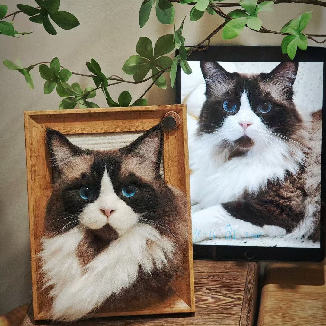 Wooden frame with a cat picture on a wooden surface with green leaves in the background